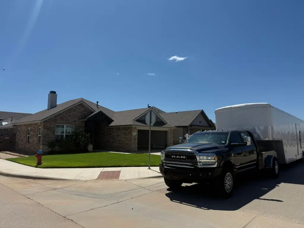 First Class Relocation crew finishing a 48-hour move-in: TV mounted, boxes unpacked, furniture assembled, and a modern living room fully set up